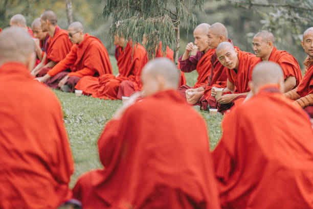 Bhutanese Monks Lunch Break Beside Dochula Pass on October 7th year 2022 Thimphu, Bhutan - October 7: Bhutanese Monks Lunch Break Sitting On Ground Beside Dochula Passon October 7, 2022 in Thimphu, Bhutan. bhutanese culture photos stock pictures, royalty-free photos & images