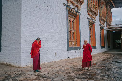 Thimphu, Bhutan - October 7: 2 Bhutanese Lama Talking in Punakha Dzong on October 7, 2022 in Punakha, Bhutan.