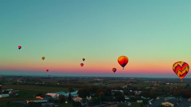 Drone View of Hot Air Balloons Floating in the Early Morning Sky During a Balloon Festival