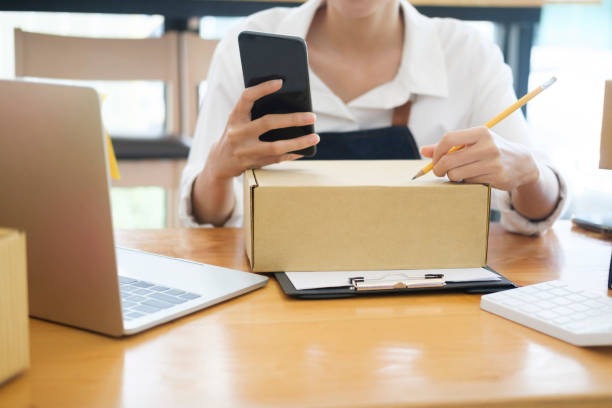istock Female online business owner checking order using cellphone. 1434297984