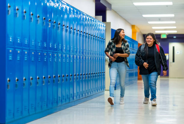 istock Best friends walking thru school corridor 1434301852