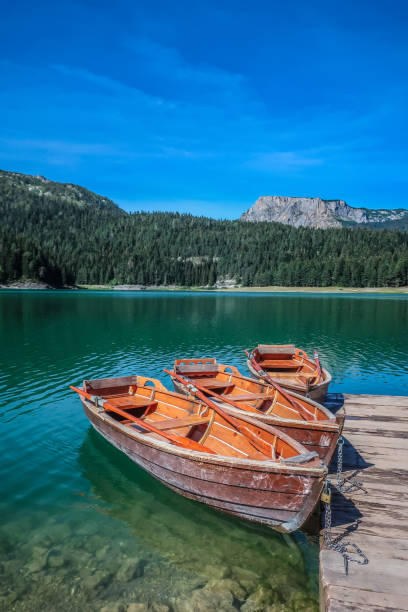 Black Lake with Boats in the Natural Park of Durmitor, Montenegro stock photo