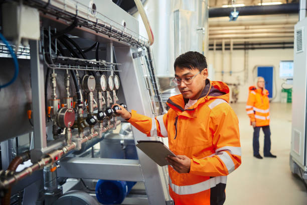 Engineer and a colleague working in a power station stock photo