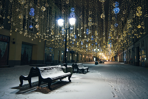 empty street without people, unusual Christmas decorations against a twilight sky. the street is decorated for the new year and Christmas. Street is decorated for Christmas. MOSCOW, RUSSIA - DECEMBER 21, 2021