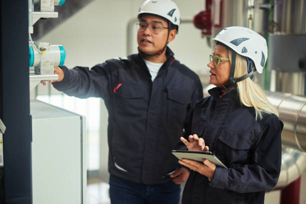istock Engineers with a tablet examining gauges while working in a power station 1434305599