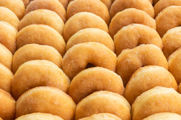 Row of Sugar Donuts Row of Sugar Coated Donuts DONUT stock pictures, royalty-free photos & images