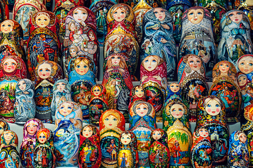 Traditional Russian souvenirs Matryoshka on shelfs in souvenir shop. lots of nesting dolls