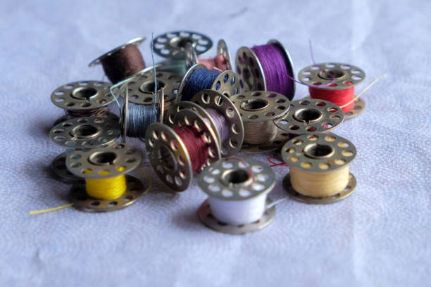 istock Multicolored threads on the bobbin from the sewing machine on a blurred background from the other bobbins 1434312572