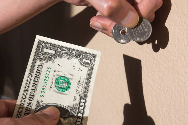 istock A person exchanging US $1 for 150 Japanese Yens 1434313524