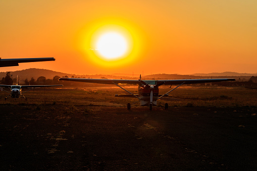Small propeller airplanes at sunset in Arusha airport, Tanzania