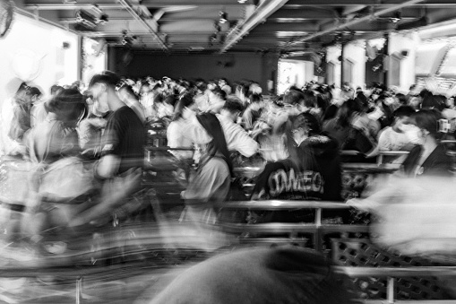 Crowd of people queuing, motion blur