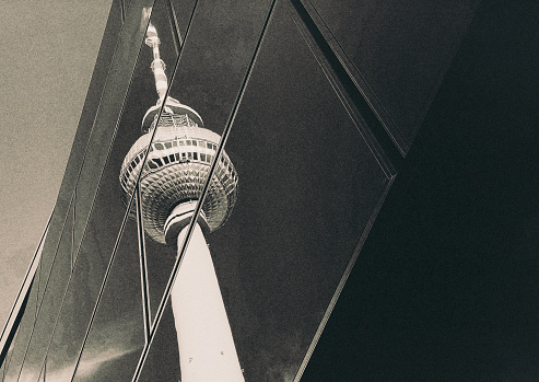 The Fernsehturm in East Berlin. Reflected in the panes of a modern shopping center.