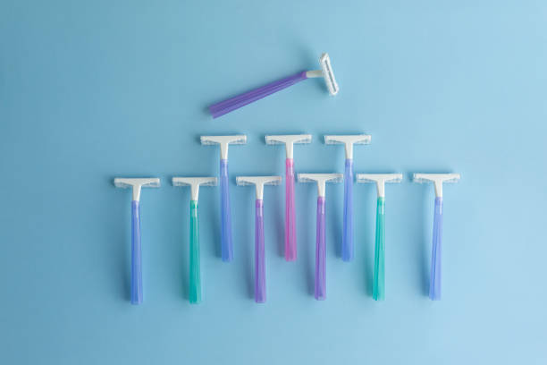 Set of multi-colored disposable razors on a blue background