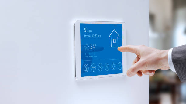 Man checking his smart home system stock photo