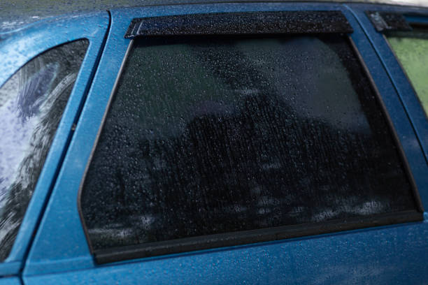 istock Tinted rear window of a car with raindrops 1434321022