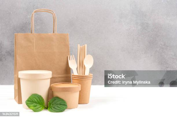Paper Utensils Food Paper Containers Bag Cups Drinking Straws And Wooden Cutlery Set Against Gray Wall Background With Copy Space Sustainable Food Packaging Eco Tableware Stock Photo - Download Image Now