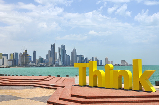 Doha, Qatar- May 5, 2010: Qatar is a fast-developing state in Middle East area and its capital Doha is a city full of wealth and dream. Here is a themed statue in seaside with the background of the skyscrapers in the downtown area, Doha.