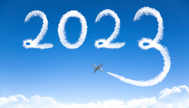 Happy New year 2023 concept. cloud drawing by airplane in sky stock photo