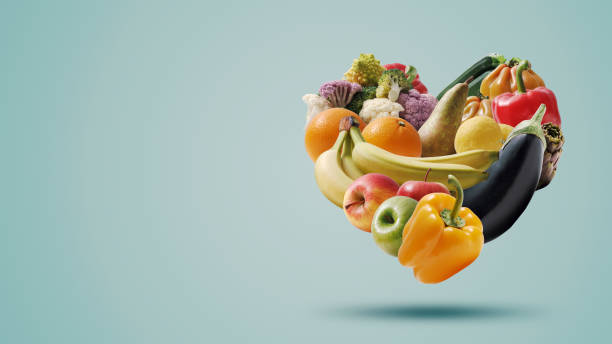 Fruits and vegetables arranged in a heart shape stock photo