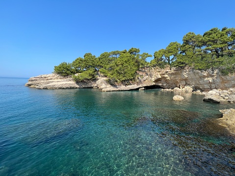 Turquoise sea bay of scenic rocky coast at summer sunny day.