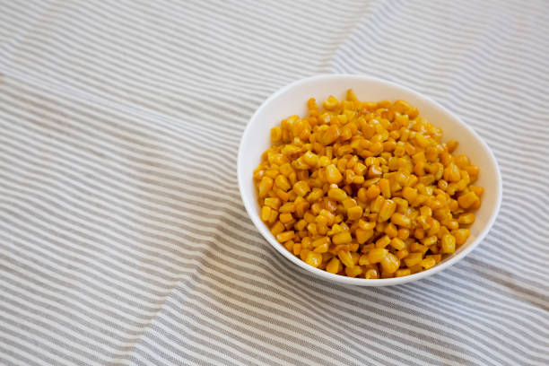 istock Yellow Roasted Sweetcorn in a White Bowl, side view. Space for text. 1434329642