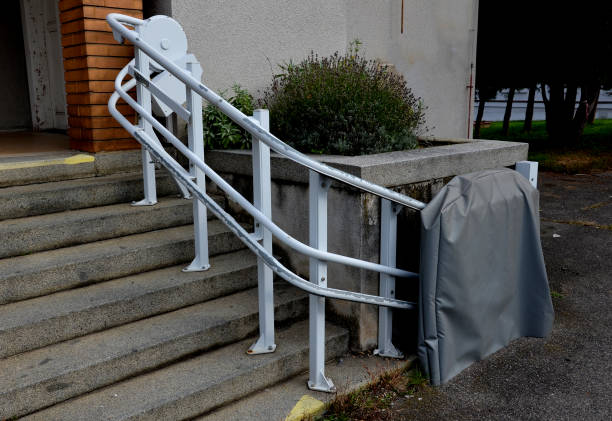 istock next to the stairs is a platform with a handrail for wheelchair users who cannot get over the barrier of the stairs. the elevator takes them up a level higher 1434334345