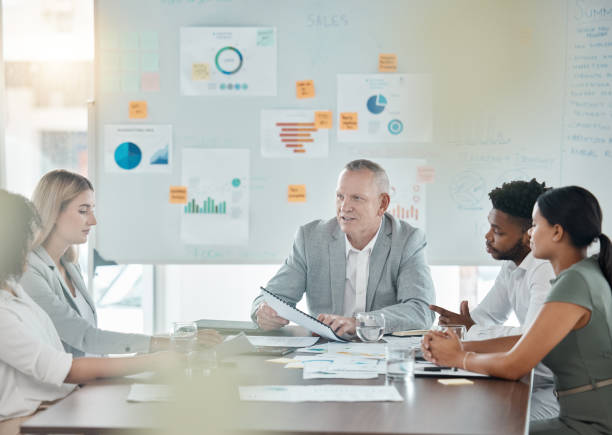 istock Meeting, training and collaboration with a manager, leader or CEO and his team in a workshop or presentation. Teamwork, learning and coaching in the boardroom for company growth or future development 1434337917