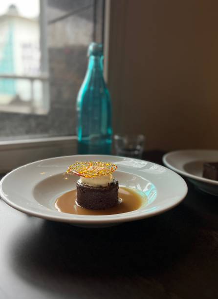 istock Sticky date pudding on a white plate with sugar snap topping and butterscotch sauce 1434339502