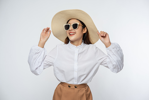 Girl wearing a white shirt and shorts wearing a hat Wear glasses and handle on the hat.
