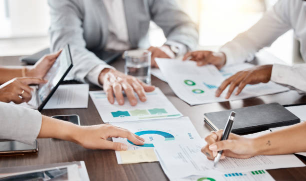 istock Business teamwork hands, paperwork and planning annual report data, research and budget in office. Company discussion with documents in strategy meeting, graphs analytics and financial stats progress 1434340921