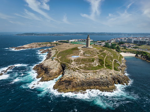 A Coruña famous ancient roman Hercules Tower - Torre de Hércules (Tower of Hercules) Coastal Lighthouse Aerial Drone View from the Atlantic Ocean. A Coruna, Galicia, Northern Spain, Spain, Europe.