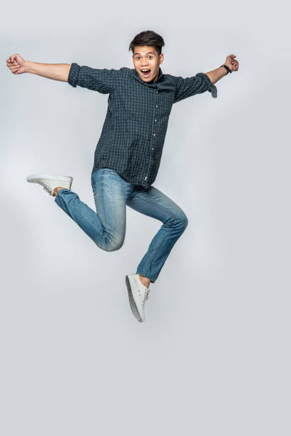 istock The man in a black shirt and jeans jumped up for joy. 1434346321