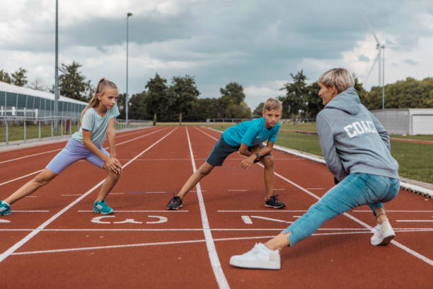 istock Athletics mother running coach working with her children during a training session 1434346370