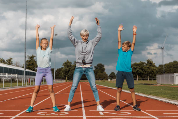 Athletics Mother Running Coach Working With Her Children During A Training  Session Stock Photo - Download Image Now - iStock