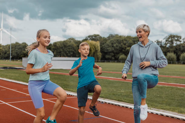 Athletics mother running coach working with her children during a training session