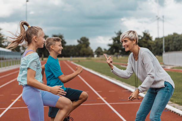 istock Athletics mother running coach working with her children during a training session 1434346380