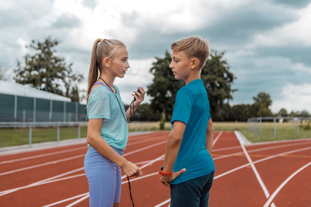 istock Athletics children running coaches at the track during a session 1434346393