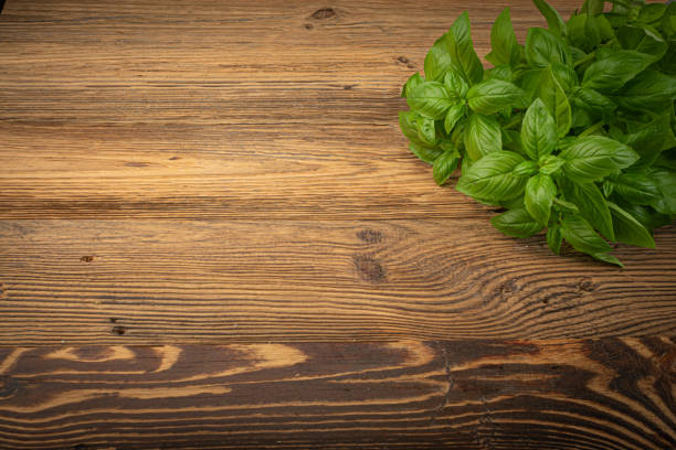 istock Fresh Basil on Wood Table Background, Green Basilic Bunch on Rustic Wooden Desk Plate 1434349636