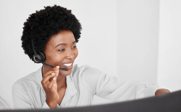 call center consultant in communication online on computer, consulting with people on the internet and support in customer care job at telemarketing company. happy african receptionist on phone call - asking on the phone call center customer service representative imagens e fotografias de stock