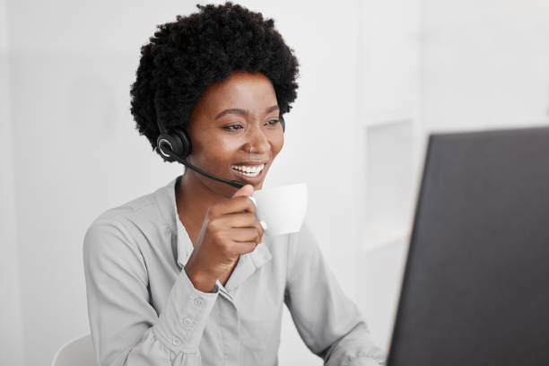 istock Call center, customer support and coffee with a woman consultant working on a computer in her office. Telemarketing, crm and contact us with a female consulting for help and service with a headset 1434350858