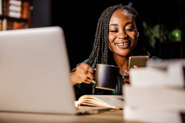 istock Young woman on a coffee break from studying using smart phone for fun 1434350938