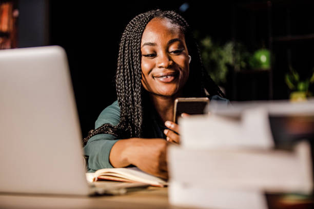istock Young woman on a coffee break from studying using smart phone for fun 1434350942