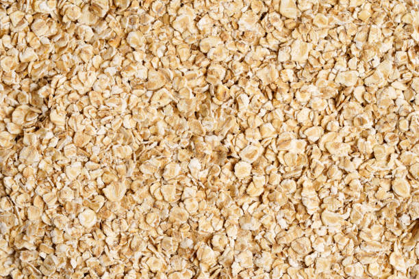 rolled oat, oat flakes background or texture. close up, directly above. - oatmeal rolled oats oat raw imagens e fotografias de stock