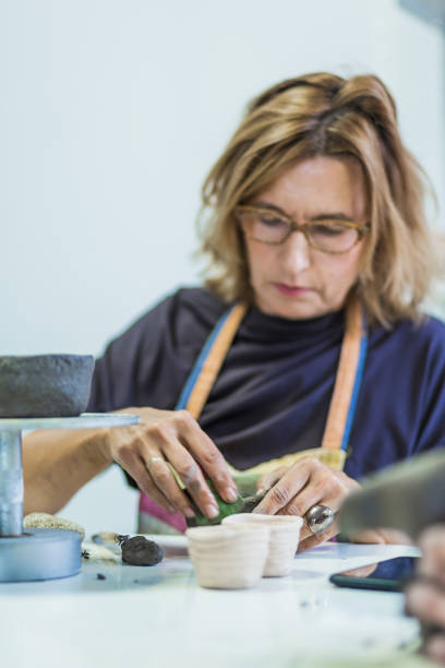 istock Mid adult woman learning ceramic art 1434351369