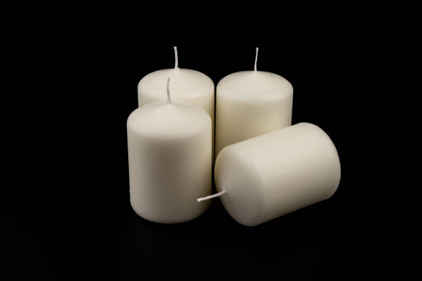istock White candles on dark background. Close-up, copy space. 1434352040