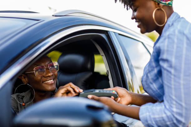 istock Service person holding a payment terminal while customer is paying with a credit card 1434356338