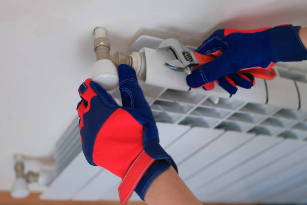 istock Plumber with wrench is working and installing heating system in apartment 1434357722