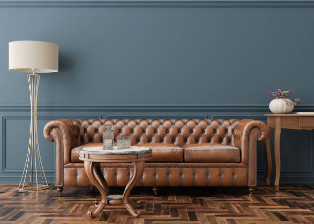 istock Empty blue wall in modern living room. Mock up interior in classic style. Copy space for your picture, poster. Template for artwork. Brown leather sofa, parquet floor, wall molding. 3D rendering. 1434359306
