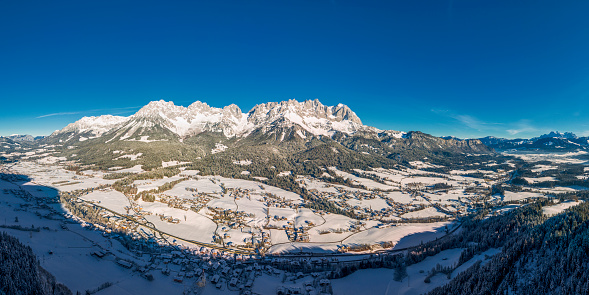 Beautiful panoramic view of historic Gosau mountain village on a scenic cold sunny day with blue sky and clouds in winter, Salzkammergut, Upper Austria region, Austria