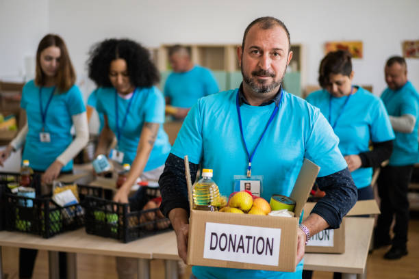istock A charity worker with a charity grocery box 1434362452